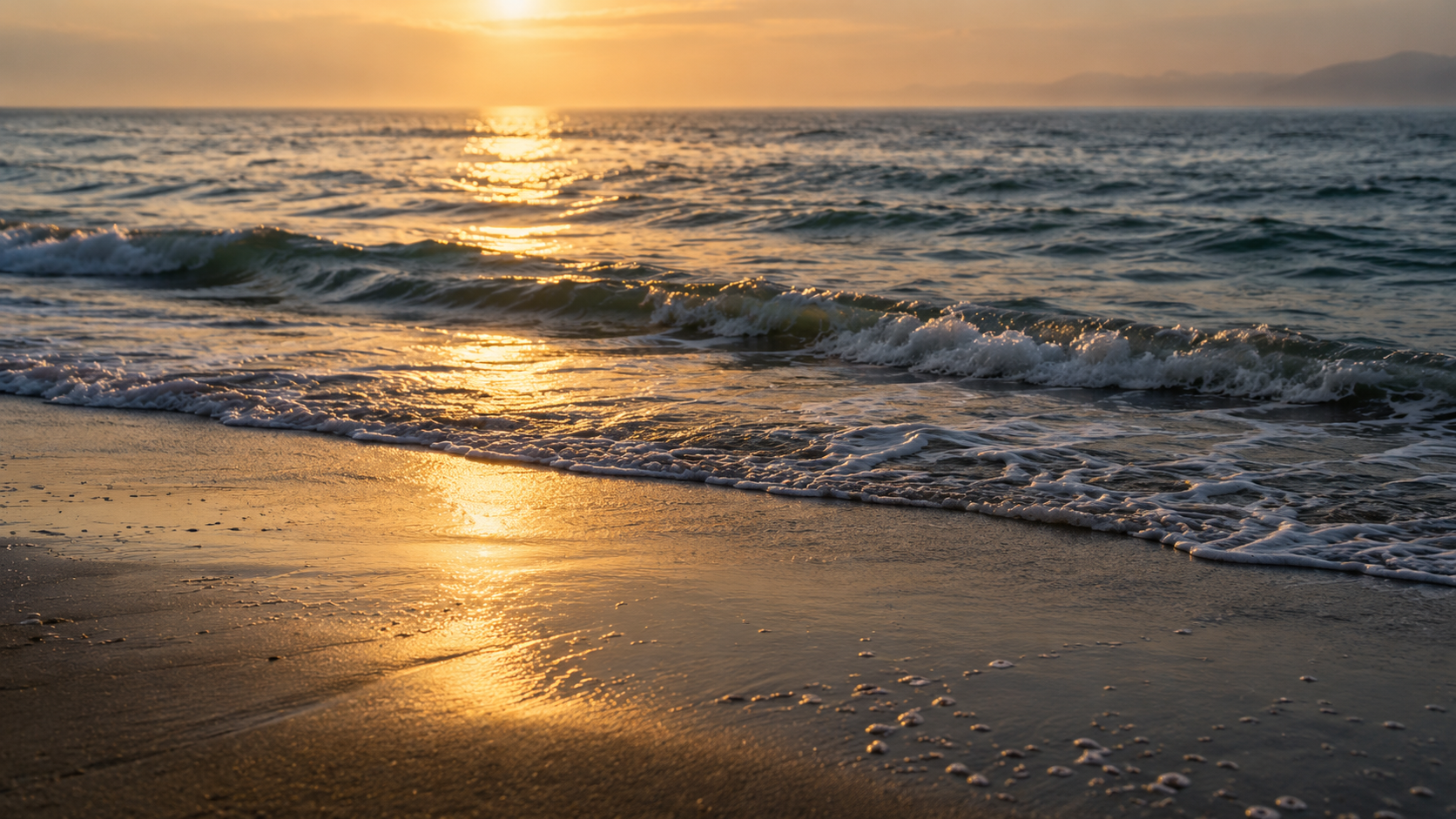 Soft golden light reflected in gentle ocean waves